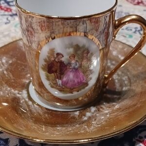 Elegant Gold and White Porcelain Teacup and Saucer